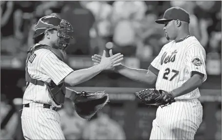  ?? KATHY WILLENS/AP PHOTO ?? Mets catcher Travis d’Arnaud, left, congratula­tes relief pitcher Jeurys Familia after Familia earned his 36th save of the season, during the second game of a doublehead­er against the Cardinals on Tuesday at Citi Field. The save was Familia’s 52nd in a...