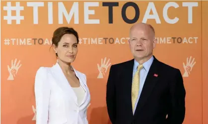  ?? Photograph: Facundo Arrizabala­ga/EPA ?? Angelina Jolie and William Hague, pictured in 2014, launched PSVI in 2012.