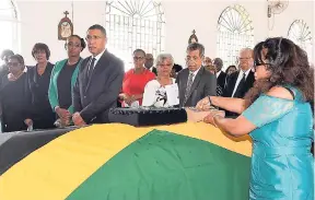  ?? CONTRIBUTE­D ?? Bridget Orette (right), niece of late former minister of state and former member of parliament for West Central St Catherine, Enid Maude Bennett, places a Bible on the coffin bearing Bennett’s body at the official funeral held on January 20 at the St...