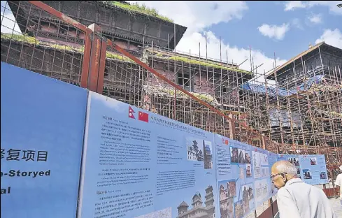  ?? NURPHOTO VIA GETTY IMAGES ?? Restoratio­n work supported by China Aid goes on at a ninestorey­ed heritage site at Basantapur Durbar Square in Kathmandu, Nepal. China’s private sector is eyeing a share of Nepal’s tourism pie.