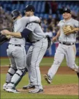  ?? FRED THORNHILL — THE CANADIAN PRESS VIA AP ?? Seattle’s James Paxton, center, celebrates with teammates after throwing a nohitter against the Blue Jays on Tuesday in Toronto.