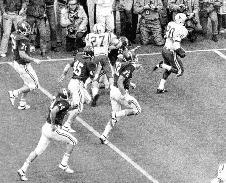 ?? Bob Gorham Lincoln Journal Star via AP file ?? On Thanksgivi­ng Day 1971, Nebraska’s Johnny Rodgers returns a punt for a touchdown during the Cornhusker­s’ 35-31 win over Oklahoma in the “Game of the Century.”