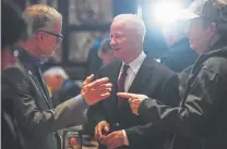  ?? Michael Ciaglo, Special to The Denver Post ?? Aurora mayoral candidate Mike Coffman, center, chats with current Aurora Mayor Bob LeGare, left, during Coffman’s election night watch party at BJ’s Restaurant & Brewhouse.