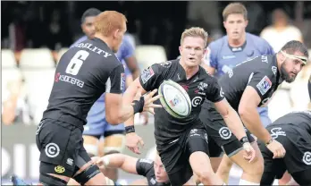  ??  ?? Michael Claasens of the Cell C Sharks pops the ball out to his captain, Phillip van der Walt, during the Super Rugby encounter against the Western Force at Kings Park in Durban yesterday.