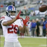  ?? BILL KOSTROUN — THE ASSOCIATED PRESS ?? New York Giants running back Saquon Barkley (26) warms up before an NFL football game against the New York Jets, Friday in East Rutherford, N.J.