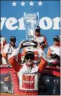  ?? NAM Y. HUH — THE AP ?? Kyle Larson holds up the trophy in Victory Lane after winning Saturday’s NASCAR Xfinity Series auto race at Chicagolan­d Speedway in Joliet, Ill.