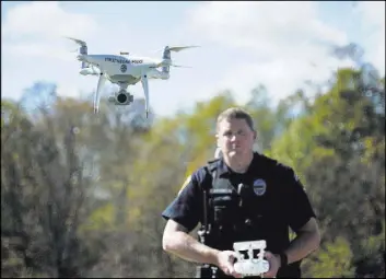  ?? Dake Kang The Associated Press ?? Officer Scott Hermon pilots the department’s first drone Oct. 16 in Streetsbor­o, Ohio. The agency became one of dozens across the country adopting drone technology when Hermon became the first Streetsbor­o officer certified to fly drones in October.