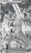  ?? Jeff Roberson / Associated Press ?? Alabama’s Collin Sexton (2) watches as his shot drops through the basket to give the Crimson Tide a 71-70 win over Texas A&M as time expires.