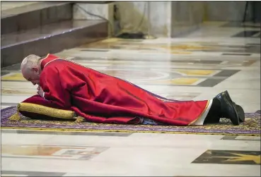  ?? ANDREW MEDICHINI — THE ASSOCIATED PRESS ?? Pope Francis lies down in prayer prior to celebrate Mass for the Passion of Christ, at St. Peter’s Basilica, at the Vatican, Friday, April 10.
