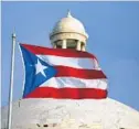  ?? RICARDO ARDUENGO/AP ?? The Puerto Rican flag flies in front of Puerto Rico’s Capitol in San Juan.