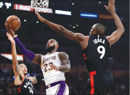  ?? Jose Sanchez) (AP Photo/Marcio ?? Los Angeles Lakers' LeBron James (23) drives to the basket between Toronto Raptors' Serge Ibaka (9) and Danny Green (14) during the first half of an NBA basketball game Sunday, Nov. 4, 2018, in Los Angeles.