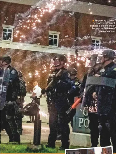  ?? The New York Times ?? ■ Fireworks thrown by protesters erupt behind a police line in Ferguson, Montana.