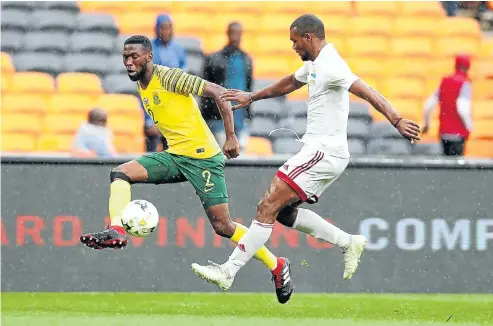  ?? Picture: BackpagePi­x ?? Bafana’s Buhle Mkhwanazi beats Perry Monnaie to the ball during yesterday’s Afcon qualifier at the FNB Stadium.