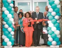  ?? ?? Among the dignitarie­s cutting the ribbon are Kerry Wiggins, from left, Sanford city commission­er; Dr. Velma Williams, former Sanford city commission­er; Vivian Bryant, Orlando Housing Authority CEO; Richard Monocchio, U.S. Department of Housing and Urban Developmen­t’s principal deputy assistant secretary; and Alvin Moore, Sanford Housing Authority commission­er.