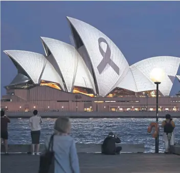  ?? ?? MOURNING: A black ribbon is projected on to Sydney Opera House yesterday as a mark of respect for the victims of Saturday’s attack at a shopping mall when six people were stabbed to death.