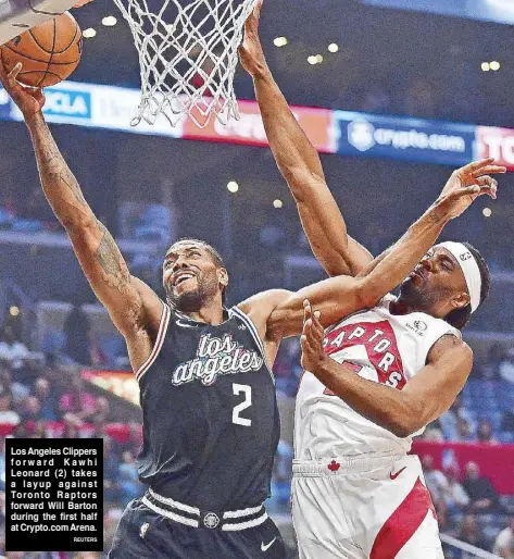  ?? REUTERS ?? Los Angeles Clippers forward Kawhi Leonard (2) takes a layup against Toronto Raptors forward Will Barton during the first half at Crypto.com Arena.