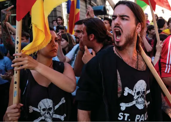  ?? Photo: Jack Taylor/Getty ?? Protesters chant at a group of Spanish National Police during a Catalan pro-independen­ce strike of university students yesterday in Barcelona. The Parliament of Catalonia will meet today for a two-day plenary session to debate the applicatio­n of...