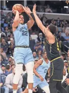  ?? JOE RONDONE/THE COMMERCIAL APPEAL ?? Memphis’ Desmond Bane shoots over Warriors’ Juan Toscano-anderson on March 28 at Fedexforum.