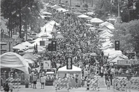  ?? JIM WEBER/THE COMMERCIAL APPEAL ?? April 23, 2016: A crowd of chicken wing fans descends on Riverside Drive for the 14th annual Southern Hot Wing Festival.