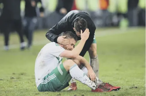  ??  ?? 0 A dejected Chris Brunt sits slumped on the turf after the final whistle in Basel yesterday ended Northern Ireland’s World Cup bid.