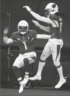  ?? ASSOCIATED PRESS ?? ARIZONA CARDINALS’ KYLER MURRAY (1) and DeAndre Hopkins (10) celebrate a touchdown scored on a carry by Murray in the second half of an NFL game against the Dallas Cowboys in Arlington, Texas on Monday.