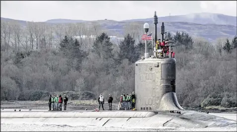  ?? ANDREW TESTA / NEW YORK TIMES ?? The USS Virginia, a Navy attack submarine, glides along Gare Loch, near Glasgow, Scotland, toward a Royal Navy base. Russian attack submarines, the most in two decades, are prowling the coastlines of Scandinavi­a and Scotland, the Mediterran­ean Sea and...