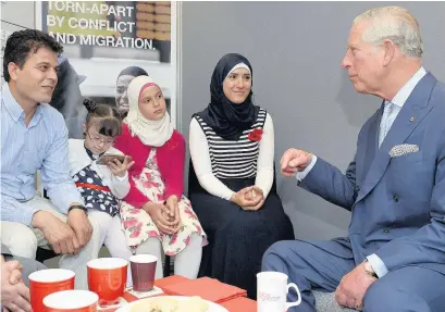  ??  ?? ■ The Prince of Wales meets Syrian refugee Moussa Al Sharki and his family Hala, Rayan and Raaja, who now live in Cardiff, during a visit to the British Red Cross charity’s centre in Islington ANTHONY DEVLIN