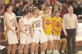  ?? Photo by Becky Polaski ?? Players on ECC’s bench react to Michael Jacobs getting a chance at a three-point play after being fouled making a field goal in the third quarter.