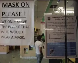  ?? Myung J. Chun Los Angeles Times ?? A SIGN AT a Chinatown business reminds customers to wear a mask. L.A. County’s indoor mask mandate when into effect 11:59 p.m. Saturday.