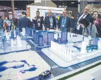  ?? DAVID RAMOS GETTY IMAGES FILE PHOTO ?? Visitors check 5G smart city technology at the China Mobile booth at the GSMA Mobile World Congress 2019 in Barcelona. The U.S. has led a blacklisti­ng of Huawei products.