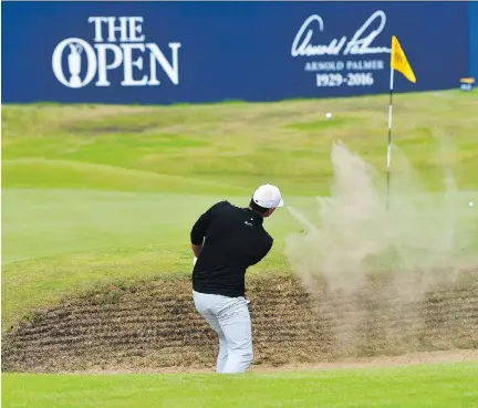  ?? STUART FRANKLIN/GETTY IMAGES ?? U.S. Open champion Brooks Koepka takes a shot from the 18th-hole bunker Thursday during the first round of the 146th British Open, at Royal Birkdale in Southport, England. His 5-under 65 put him in a tie for the lead with fellow Americans Jordan Spieth...