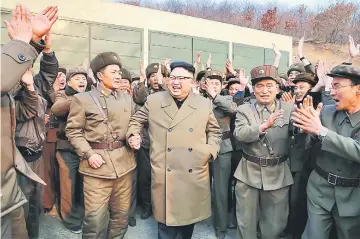  ??  ?? Picture from North Korea’s official Korean Central News Agency (KCNA) shows Kim Jong-Un (centre) inspecting the ground jet test of newly developed high-thrust engine at the Sohae Satellite Launching Ground. — AFP photo