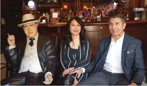  ?? The Sentinel-record/donald Cross ?? ■ Saddiq and Jeannie Mir are interviewe­d at the Ohio Club, seated next to its infamous statue of a notorious former patron, gangster Al Capone.