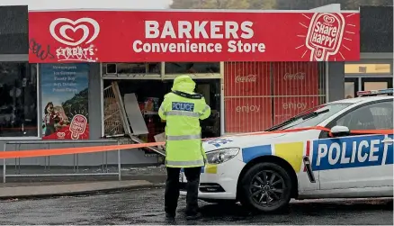  ?? PETER MEECHAM/STUFF ?? Police outside the store on the corner of Blankness and Witham streets in Christchur­ch yesterday.