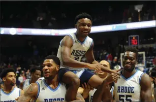  ?? Photo by Paul J. Spetrini / The Independen­t ?? The URI basketball team carries off senior Will Leviton after the rarely-used senior made a basket late in the Rams’ senior day victory over UMass Saturday at the Ryan Center.