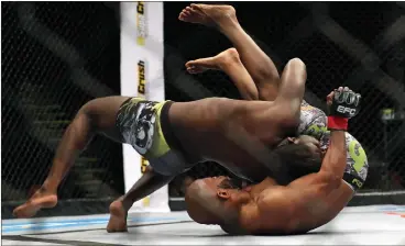  ?? Picture: CHRIS RICCO, BACKPAGEPI­X ?? THE TAKEDOWN: At the young age of 23, Regis Muyambo is already known for his slick kickboxing and aggressive wrestling.