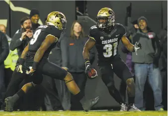  ?? Justin Edmonds / Getty Images ?? Linebacker Kenneth Olugbode, celebratin­g his fumble recovery and return for a touchdown Saturday against Utah, is part of a Colorado team that reeled off six straight Pac-12 wins.