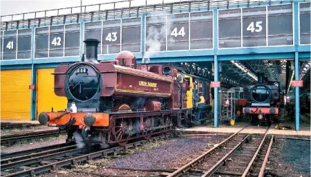  ?? DAVID BRABHAM ?? Red reunion: Pannier tank No. L99 shunts an original LT brake van at Neasden, while classmate No. L90 is repainted by LU staff in May 1993.