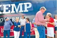  ?? AP PHOTOS/JEFF AMY ?? Georgia Gov. Brian Kemp makes notes before giving a speech on Saturday in Watkinsvil­le, Ga.