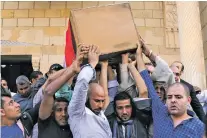  ?? ALAA ELKASSAS/THE ASSOCIATED PRESS ?? People carry the coffin of police Capt. Ahmed Fayez, who was killed in a gun battle Friday, on Saturday during his funeral at Al-Hosary mosque, in Cairo, Egypt. At least 54 policemen, including 20 officers and 34 conscripts, were killed when a raid on...