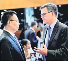  ?? — Reuters photo ?? File photo shows Dennis Shea (right) US Ambassador to the WTO talks with Zhang to the WTO before the General Council meeting at the WorldTrade Organisati­on (WTO) in Geneva, Switzerlan­d.