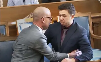  ?? Associated Press ?? Kyle Rittenhous­e, right, is comforted by his lawyer after he was acquitted of all charges at the Kenosha County Courthouse in Kenosha, Wis., on Friday.