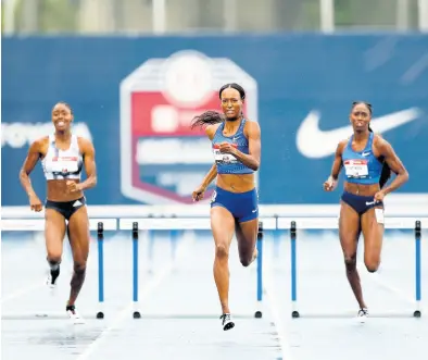  ?? AP ?? Dalilah Muhammad (centre) eyes the finish line as she wins the women’s 400m hurdles in world record time at the US Championsh­ips in Des Moines, Iowa, on Sunday.