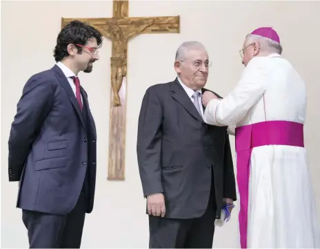  ?? Reem Mohammed / The National ?? Samir Salloum and his son Ziad were granted knighthood­s by the Vatican in a ceremony on the grounds of St Joseph’s Cathedral, where Ziad was baptised many years ago