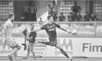  ?? — AFP photo ?? Juventus’ Portuguese forward, Cristiano Ronaldo kicks the ball during the Italian Serie A football match AC Chievo vs Juventus at the Marcantoni­o-Bentegodi stadium in Verona.