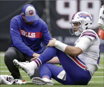  ?? MICHAEL WYKE - THE ASSOCIATED PRESS ?? Buffalo Bills quarterbac­k Josh Allen (17) is check on after he was injured during the second half of an NFL football game against the Houston Texans, Sunday, Oct. 14, 2018, in Houston.