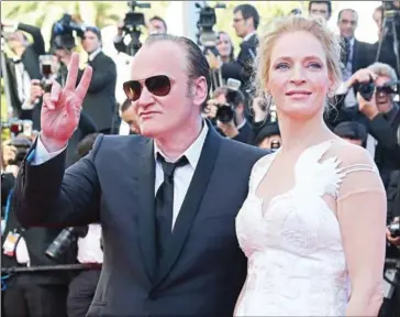  ?? LOIC VENANCE/AFP ?? US director Quentin Tarantino (left) poses with US actress Uma Thurman as they arrive for at the 67th edition of the Cannes Film Festival in Cannes, southern France on May 24, 2014.