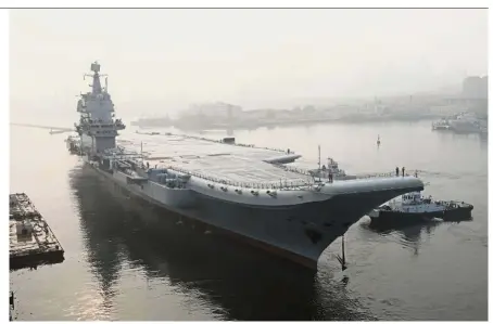  ?? — Xinhua ?? Ocean-bound: The ‘ Type 001A’ leaving a wharf in Dalian to begin sea trials.