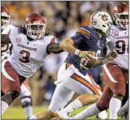  ?? NWA Democrat-Gazette/BEN GOFF ?? Arkansas defensive end McTelvin Agim pressures Auburn quarterbac­k Jarrett Stidham in the first quarter of Saturday’s loss in Auburn, Ala.