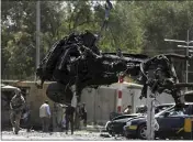  ?? RAHMAT GUL — THE ASSOCIATED PRESS FILE ?? Resolute Support forces remove a destroyed vehicle after a car bomb explosion in Kabul, Afghanista­n.